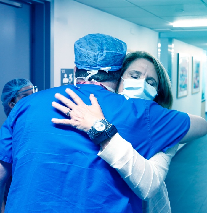 Patient hugging a doctor