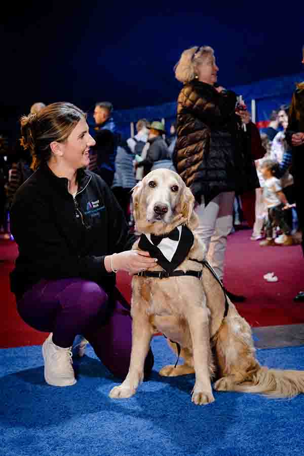 A therapy dog attends the event in black tie
