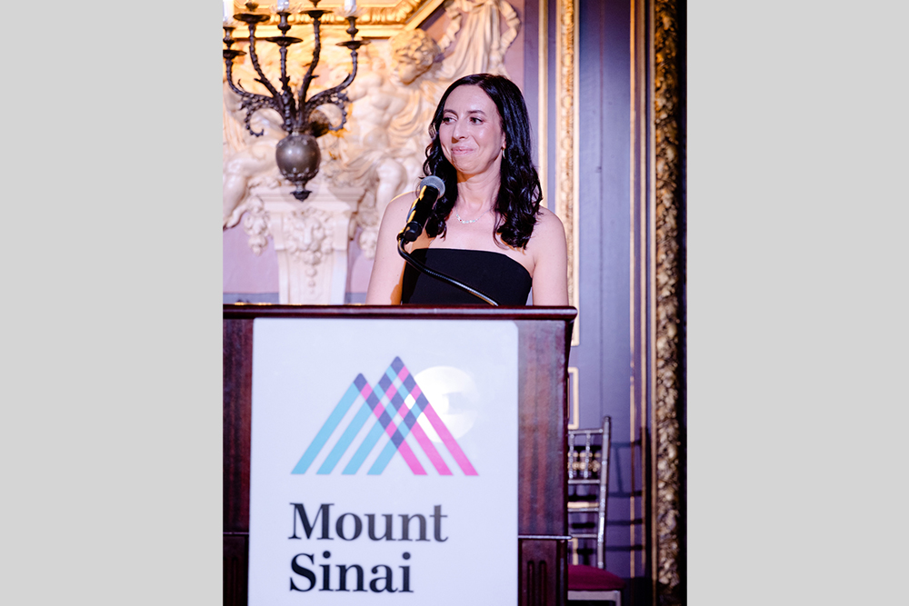 A woman speaker at a podium