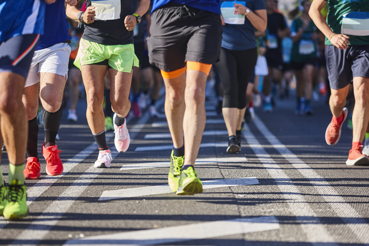 a group of people running a city race