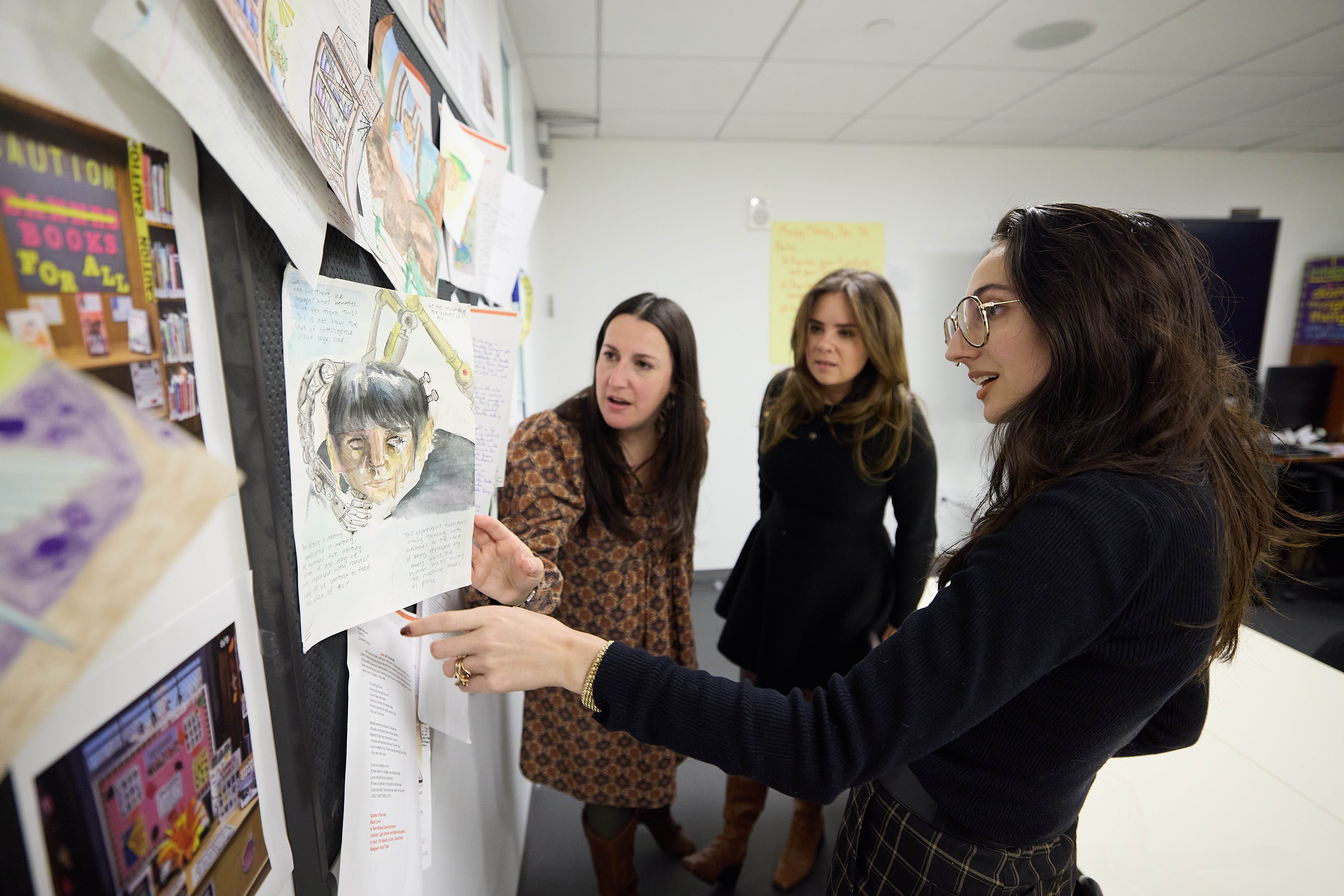 guests looking at work display