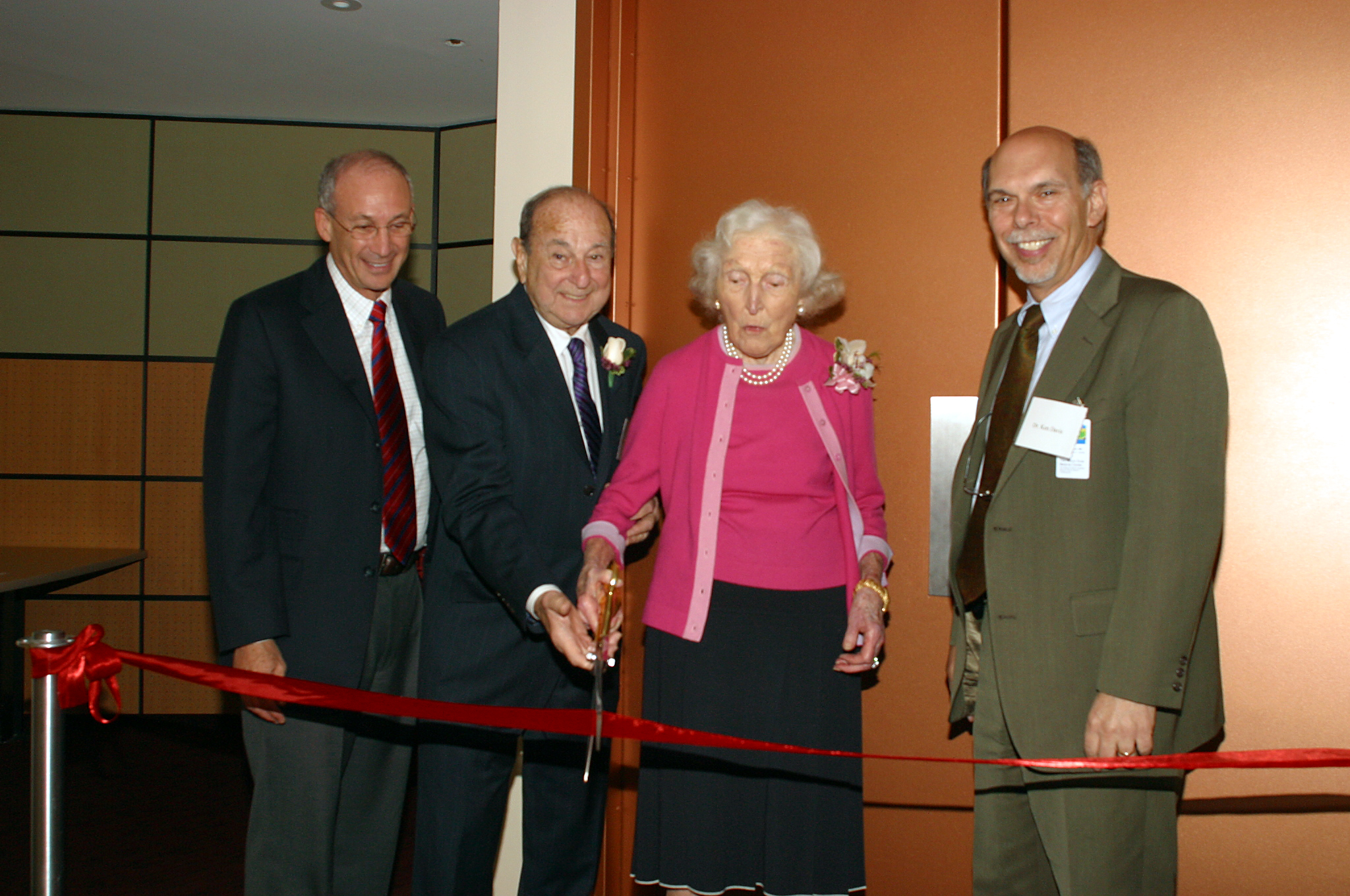 cutting ribbon Peter May, Alvin Teirstein, Kitty Gaisman, Ken Davis