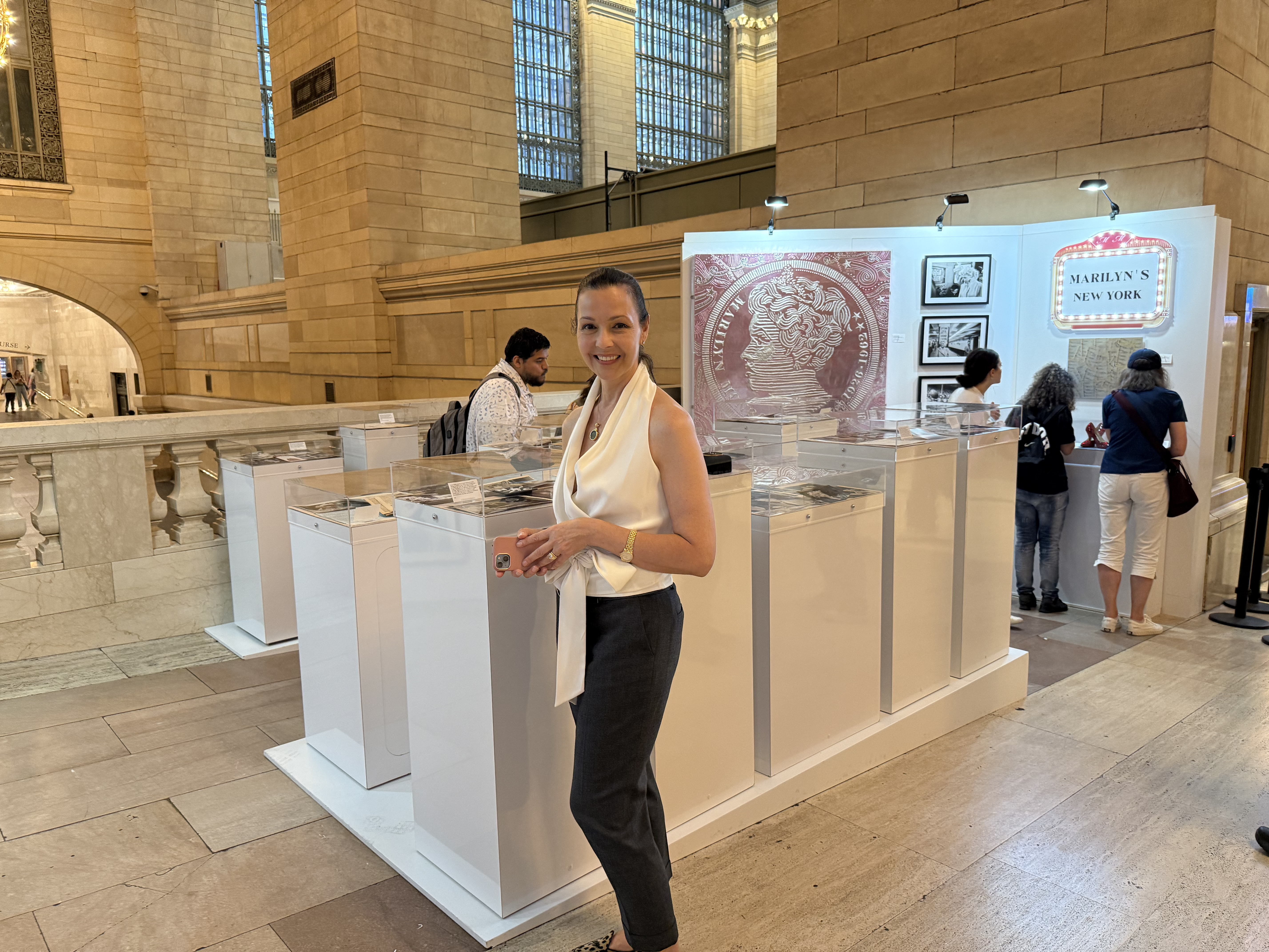 Donor Lori Hall in front of the Marilyn Monroe pop up exhibit at Grand Central