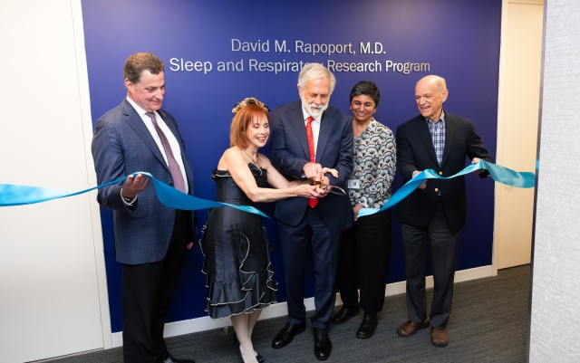 Donors David Rapoport, MD and Cheryl Kunis, MD, MS, and key leadership together cutting a ribbon recognizing the opening of the David M. Rapoport, MD Sleep and Respiratory Research Program