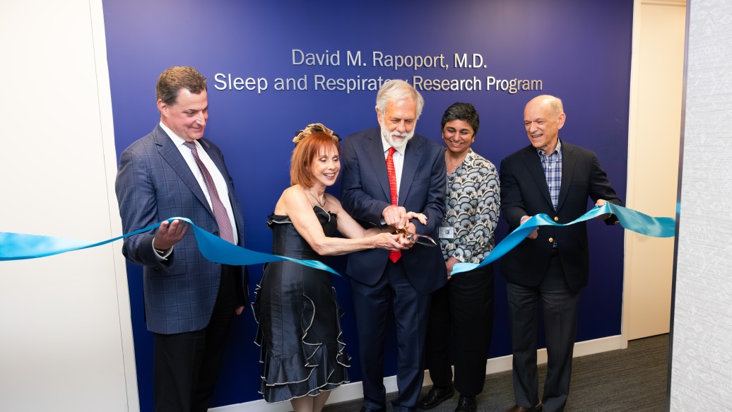 Donors David Rapoport, MD and Cheryl Kunis, MD, MS, and key leadership together cutting a ribbon recognizing the opening of the David M. Rapoport, MD Sleep and Respiratory Research Program