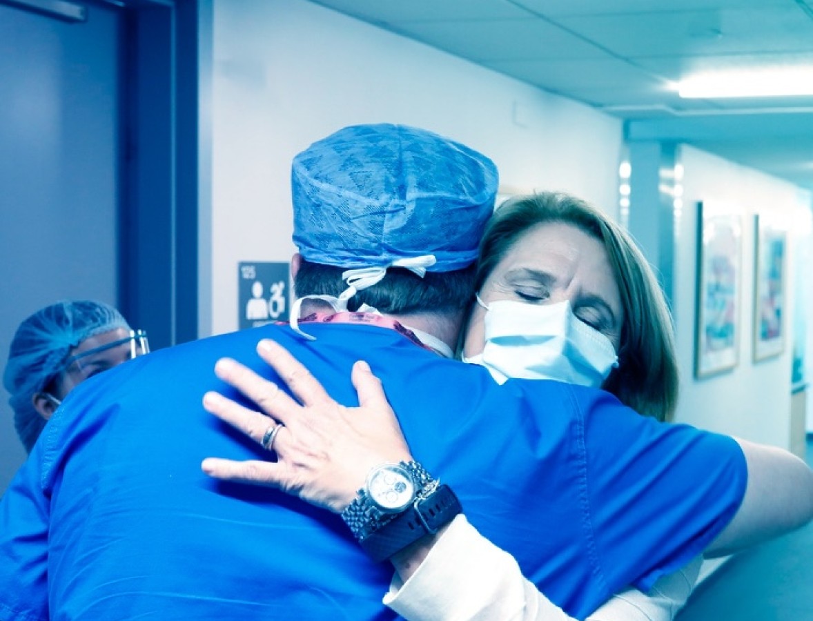Patient hugging a doctor
