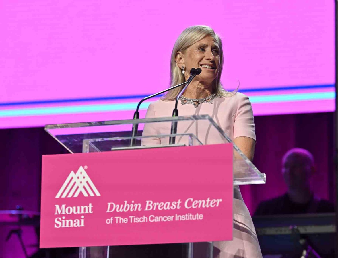 Dr. Elisa Port speaking at a podium