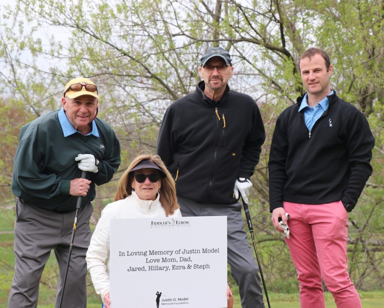 From left, Justin’s father, Hal, mother Ricki, uncle Robert, and brother Jared on the golf course