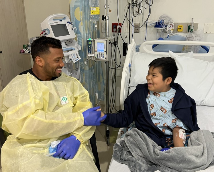 Russell Wilson with pediatric patient